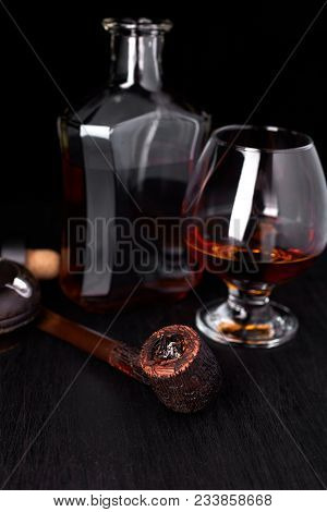 Glass Of Whiskey With Smoking Cigar.