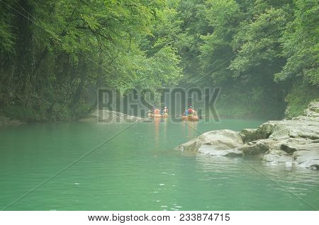 Tourists Sail On A Rubber Boat Along The Canyon Of Martvilli. Georgia