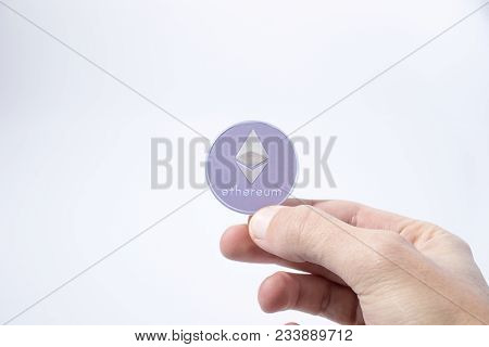 Cryptocurrency Hand Is Holding An Etherum In A Composition