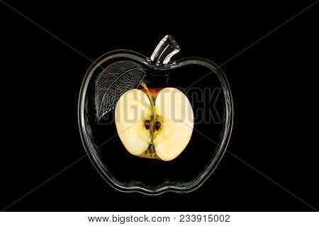 Cut Apple In A Glassware On A Black Background