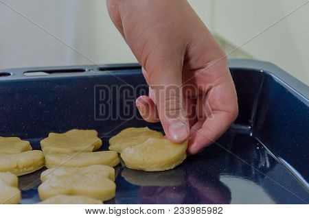 The Boy Lays Out Cookies From The Dough On A Baking Tray, Very Tasty.