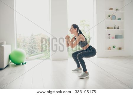 Full Size Profile Side Photo Of Joyful Agility Lover Girl Doing Sport Yoga Exercises Sit Squats Prac