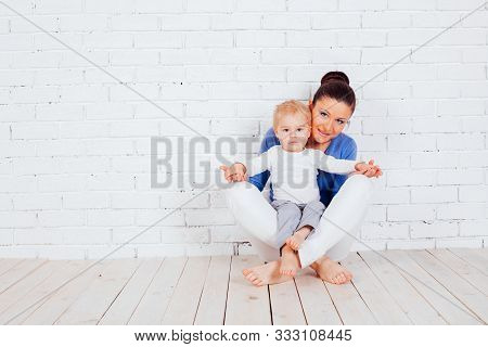 Mom And Young Boy Sitting On The Floor
