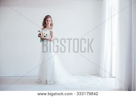 Bride In Wedding Dress Holding A Bouquet Of Flowers