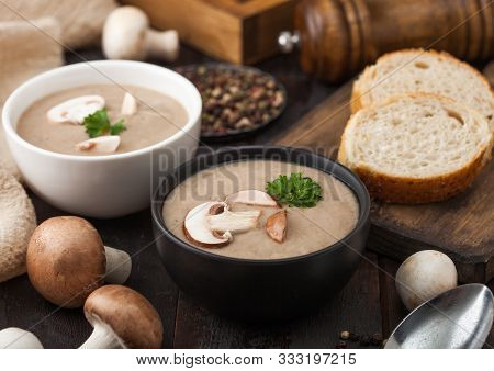 Ceramic Bowl Plates Of Creamy Chestnut Champignon Mushroom Soup With Spoon, Pepper And Kitchen Cloth
