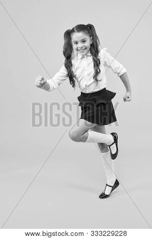 Being In A Hurry. Active Small Child In Formal Wear Rushing To School On Yellow Background. Happy Gi