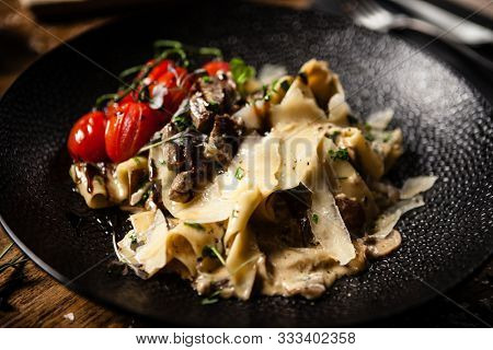 Black Angus pappardelle pasta with beef, champignon and parmegano cheese