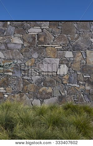 Grassy Landscape Garden Against Stone Wall