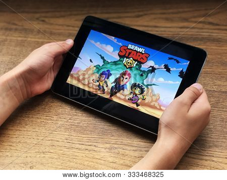 September 2019 Parma, Italy: Brawl Stars Mobile Game Application In Tablet Screen In Kid`s Hands In 