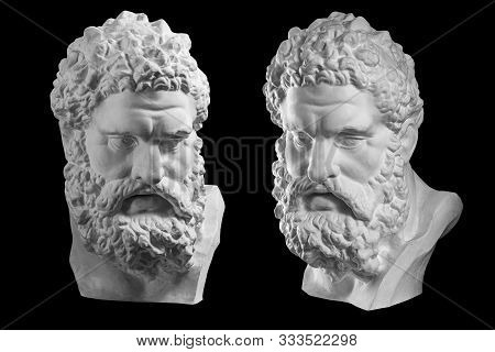 Two Bust Of Hercules. Heracles Head Sculpture, Plaster Copy Of A Statue Isolated On Black. Son Of Ze