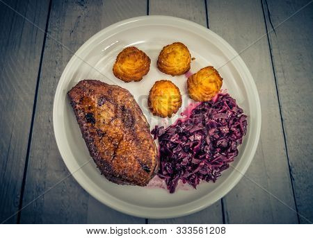 Fried Duck Breast With Red  Cabbage And Croquettes