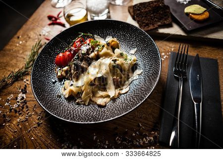 Black Angus pappardelle pasta with beef, champignon and parmegano cheese