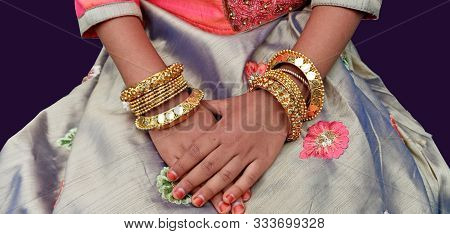 Bangles Fancy Designs On A Girls Hands. Beautiful Elegant Patterns In Gold Plated Material.  Glitter