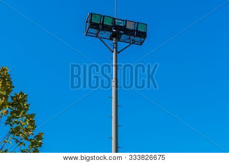 Stadium Lights With Blue Sky In Background.