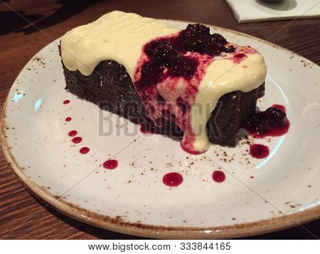 Rich Chocolate Mud Cake With Sour Cream And Berry Sauce
