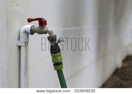 Wall Faucet There Is A Quick Connector With Rubber Hose. Faucet And Hose