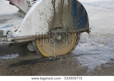 Concrete Cutting Machine Are Cutting Concrete Floor Using Cast Water To Reduce Dust Spread.