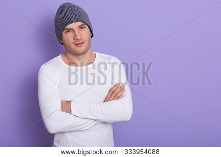 Portrait Of Young Man Standing With Hands Folded Against Lilac Studio Background, Attarctive Male We