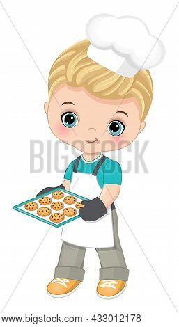 Cute Little Boy Wearing Chefs Toque, Oven And Apron Holding Baking Tray With Cookies. Cute Boy Is Bl