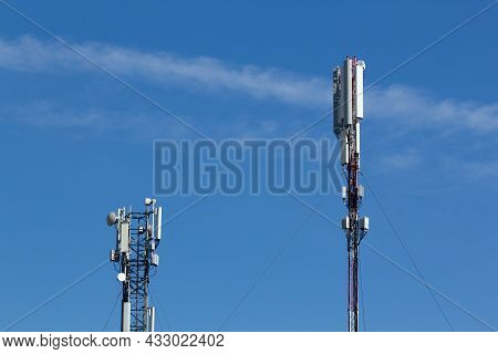 Mobile Cell Phone Tower Against The Background Of A Blue Sky And White Cloud. Telecommunication Tv T