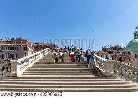 Venice, Italy - July 2, 2021: People Crossing Grand Canal At Ponte Degli Scalzi Near Luca Railway St