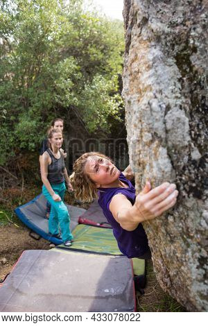 Friends Go In For Sports In Nature, Bouldering On Rocks, Girl Climbs A Big Stone, Woman Is Belayng P