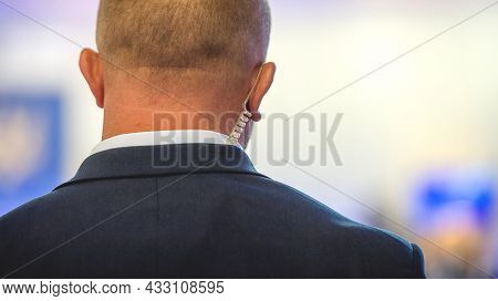 Security On Public Event. Safe Guard Service. Private Bodyguard With Earpiece Standing Among Crowd. 