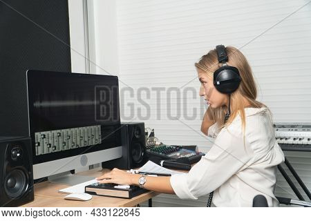 Caucasian Beautiful Woman Blonde Hair With Headphones Listening Editor On Desktop Computer Modern Wo
