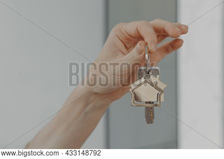 Mortgage Loan Investment. Female Hand Holding House Shaped Keychain, Cropped Shot Of Woman Showing K