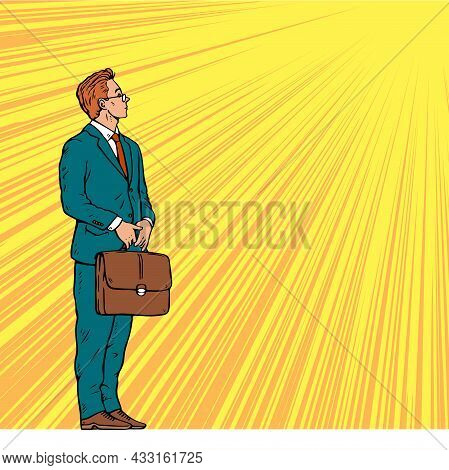 Young Businessman Stands With A Briefcase In His Hands