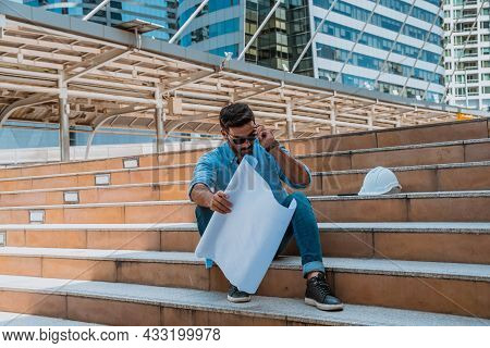 Engineer Wearing Sun Glass Look At Project Blueprints For Thinking About Building Project And How To