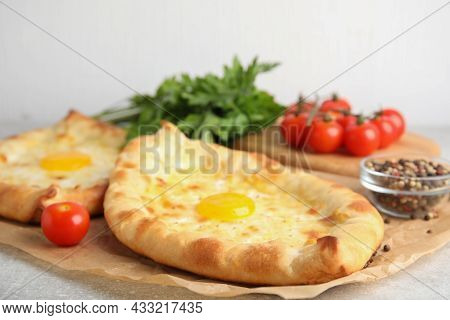 Fresh Delicious Adjarian Khachapuris Served On Grey Table