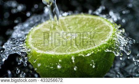 Freeze Motion Shot of Fresh Lime with Water Splash, close-up.