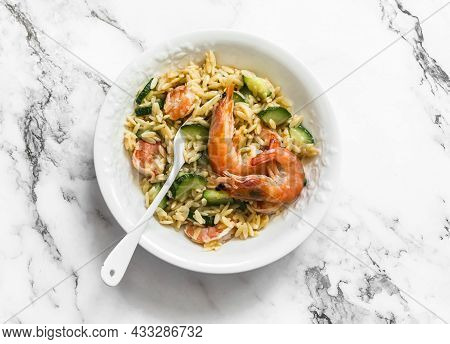 Delicious Mediterranean Lunch - Creamy Orzotto With Shrimp And Zucchini On A Marble Table, Top View