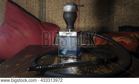 Hookah Square Flask On The Wooden Table. Original Square Designer Hookah.