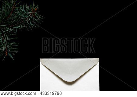 Close-up White Silk Envelope On A Black Background. Letter To Santa Claus. New Year And Christmas Co