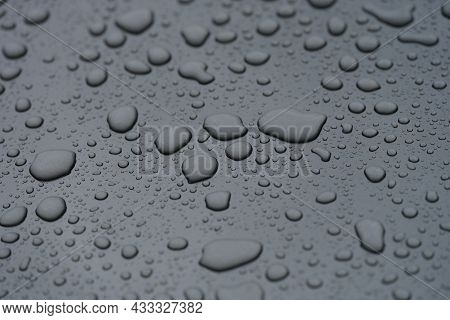 Closeup Of Raindrops On Black Hood Of Car Background