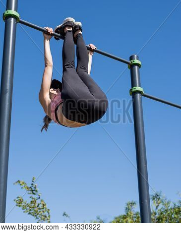 Sportive Woman Working Out On The Sports Ground In Sunny Summer Day