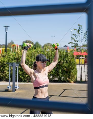 Sportive Woman Working Out On The Sports Ground In Sunny Summer Day