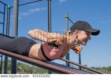 Sportive Woman Working Out On The Sports Ground In Sunny Summer Day