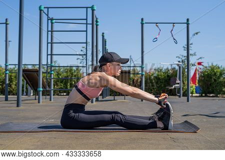 Sportive Woman Working Out On The Sports Ground In Sunny Summer Day