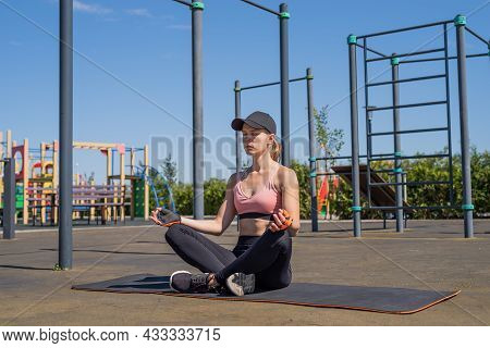 Sportive Woman Working Out On The Sports Ground In Sunny Summer Day