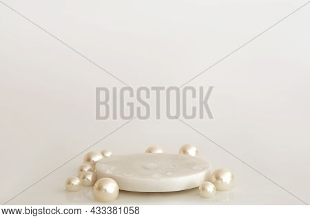 White Marble Podium With Pearls And Water Drops On The White Background. Podium For Product, Cosmeti