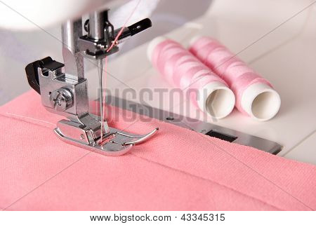 Sewing Process Of Rosy Cloth On The Machine And Two Bobbins