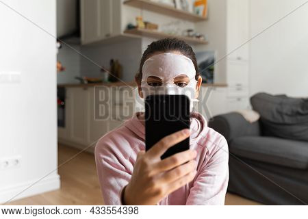Young Woman With Beauty Mask At Home. Snackable Wellness Concept. Relaxation At Home For Young Mothe