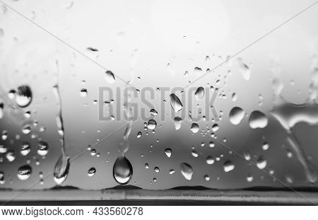 Natural Water Drop On Window Glass With Natural Light Background, Depth Of Field. Closeup Raindrop O
