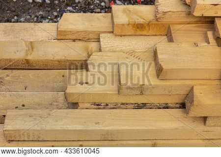 Stacked Lumber. Folded Wood.closeup Wooden Boards.the Surface Of The End Of The Board.lots Of Planks