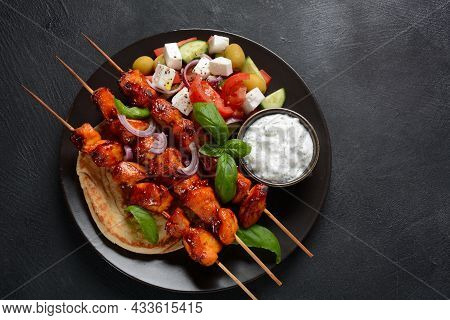Fried Souvlaki, Greek Salad And Tzatziki On Wooden Table. Chicken Skewers Souvlaki, Pita Bread - Del