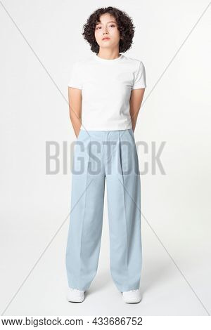 Woman in white tee and blue loose pants minimal fashion