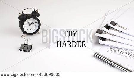 Card With Text Try Harder On A White Background, Near Office Supplies And Alarm Clock. Business